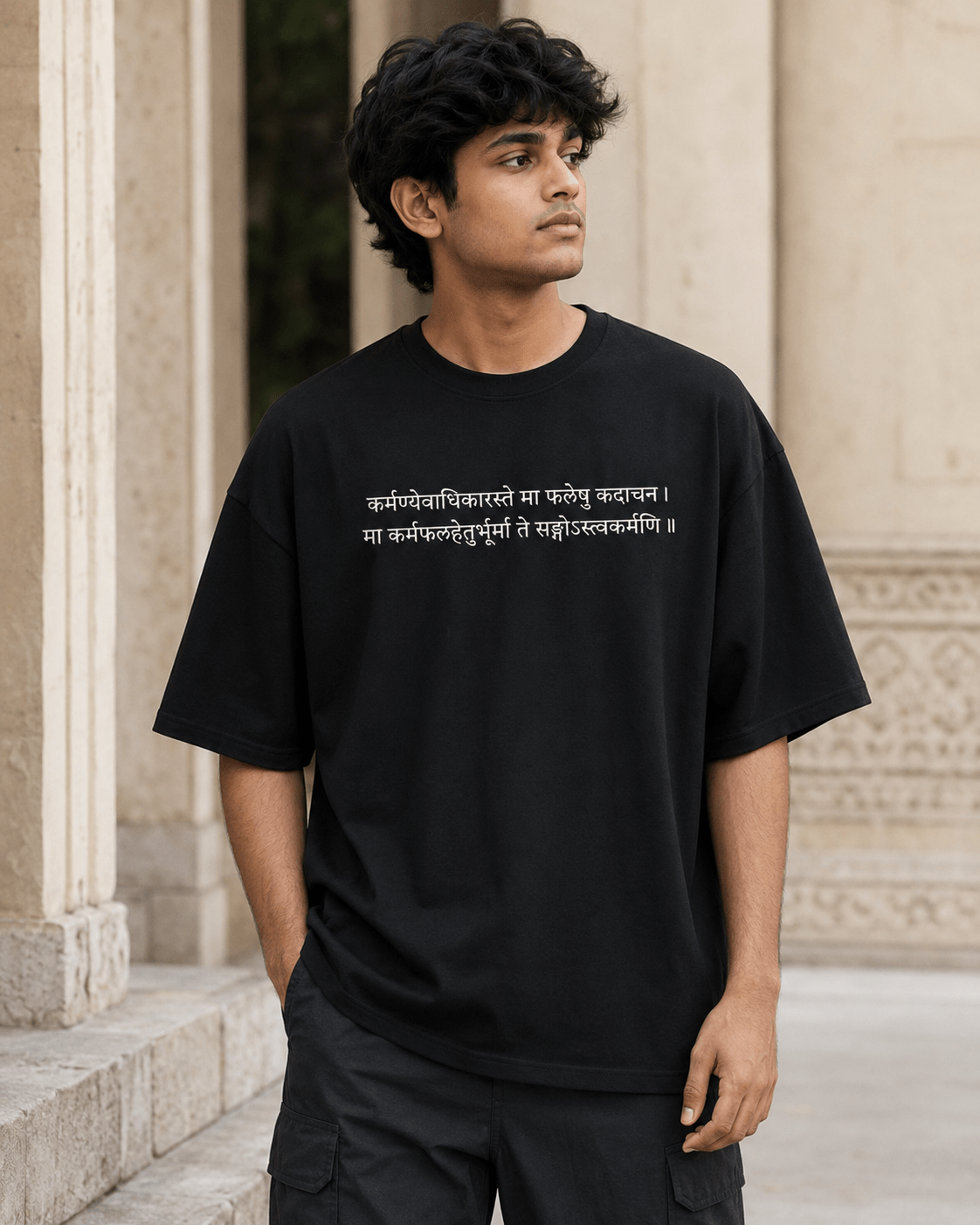 Model wearing Karma Oversized T-Shirt in black with Sanskrit shlok front chest print