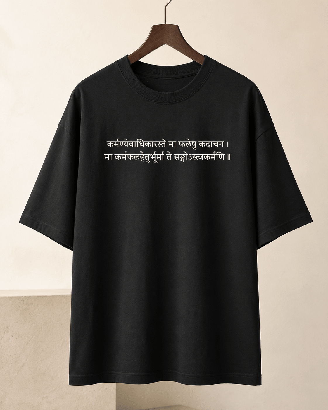 Black Karma Oversized T-Shirt on hanger with white Sanskrit shlok chest print