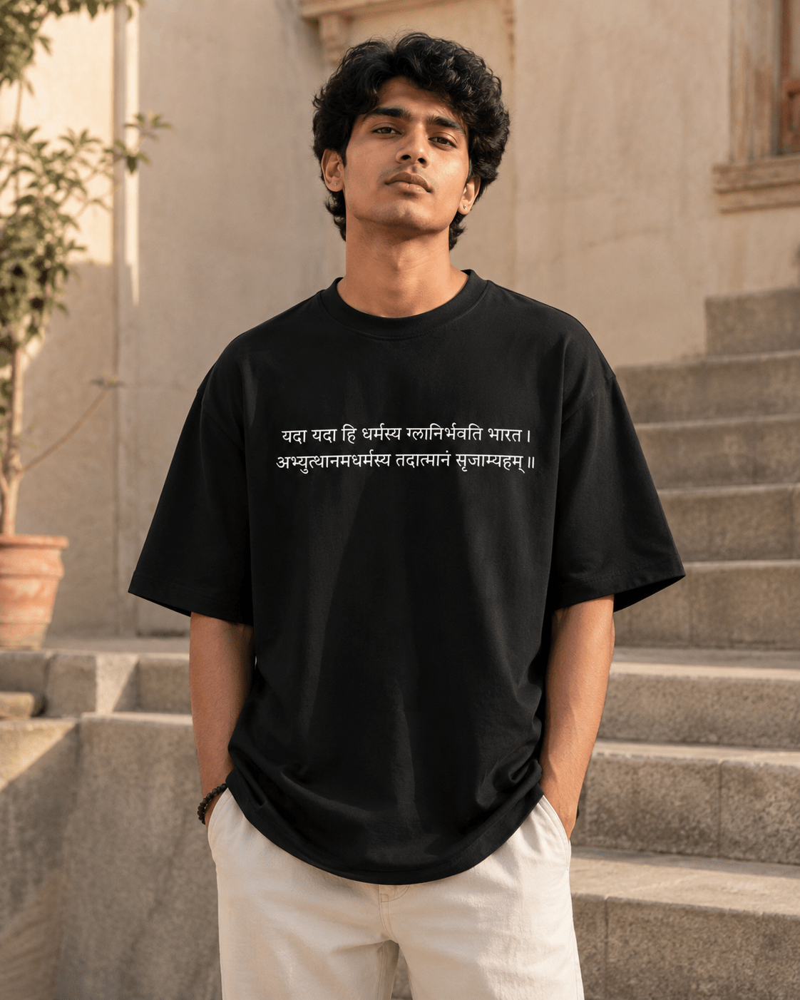 Indian model wearing black Dharma Oversized T-Shirt with Sanskrit shlok print