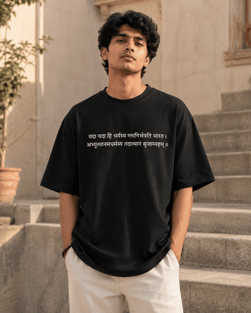 Indian model wearing black Dharma Oversized T-Shirt with Sanskrit shlok print