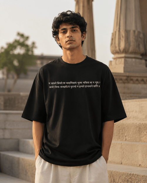 Young Indian model wearing Eternal black oversized T-shirt with Sanskrit shlok front print